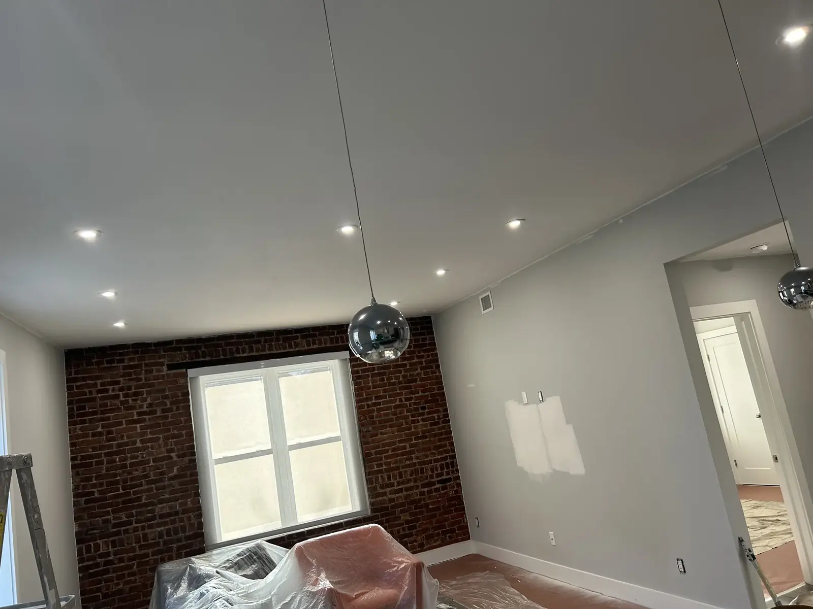 Interior room with exposed brick and protected work area